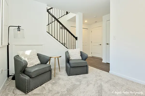 a living room with furniture and stairs