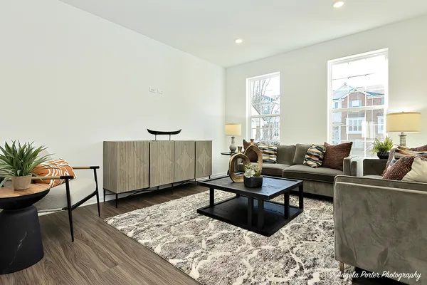 a living room with furniture a rug and a large window