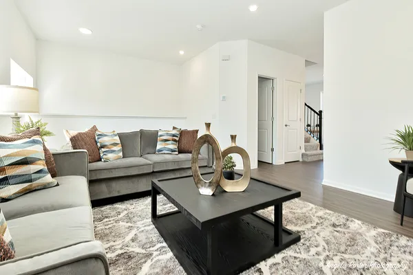 a living room with furniture and wooden floor