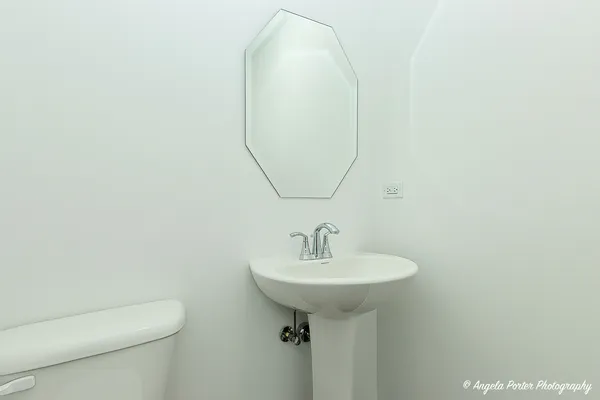 a bathroom with a sink a toilet and mirror