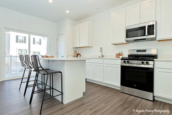 a kitchen with a stove a sink and a microwave