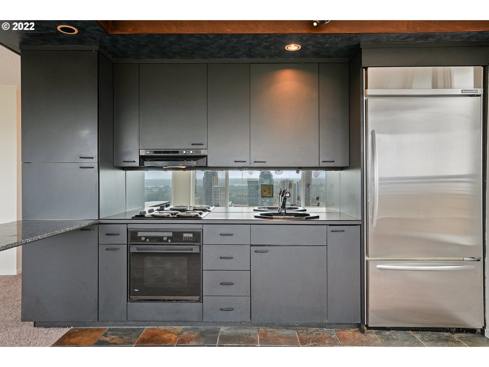 3701 Southwest Condor Avenue, Unit T3 Portland, OR 97239 - Photo 8 of 23 a kitchen with stainless steel appliances granite countertop a stove a refrigerator and a sink