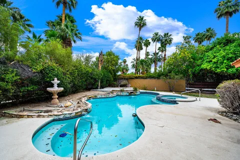 a view of a swimming pool with sitting area