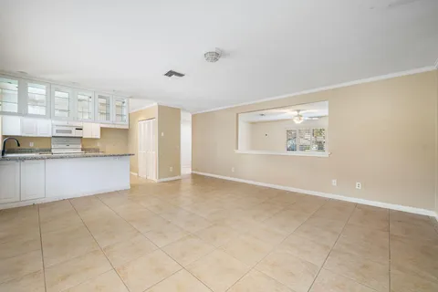 a view of a kitchen with wooden floor and a window