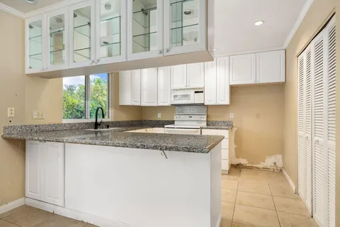 a kitchen with stainless steel appliances granite countertop a sink and a stove