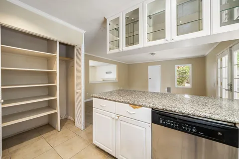 a kitchen with granite countertop cabinets and window