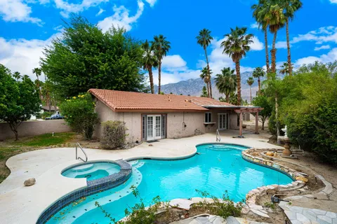 a view of a house with swimming pool patio and a yard
