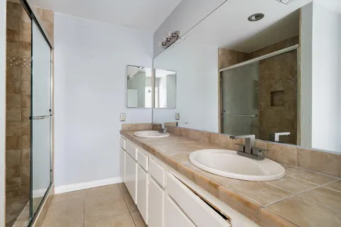 a bathroom with a sink double vanity and a mirror