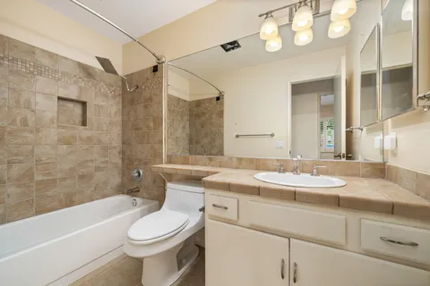 a bathroom with a sink a toilet and bathtub