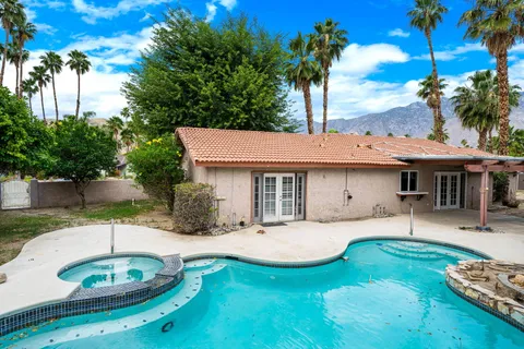 a view of a house with backyard and sitting area