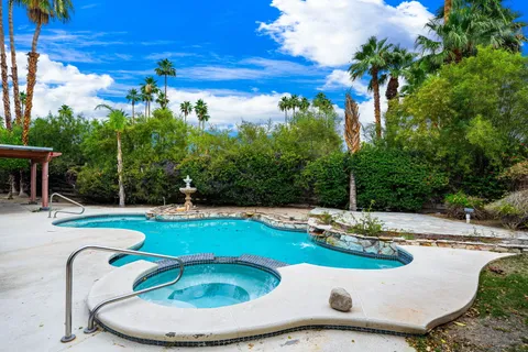 a view of a swimming pool with a yard