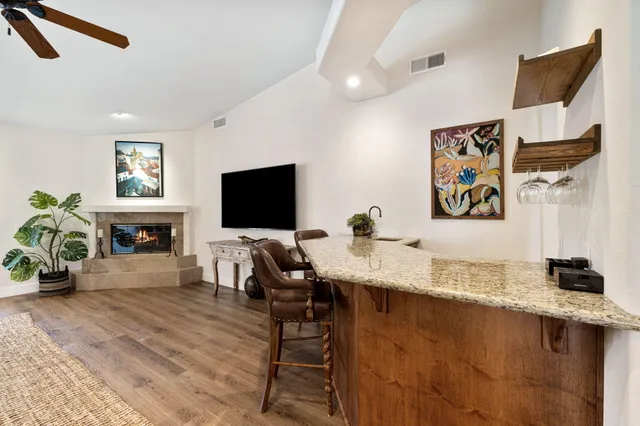 a dining room with furniture and wooden floor