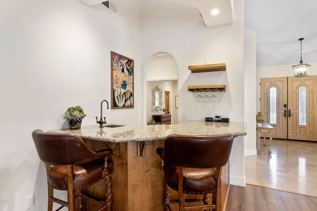 a kitchen with granite countertop a sink and cabinets