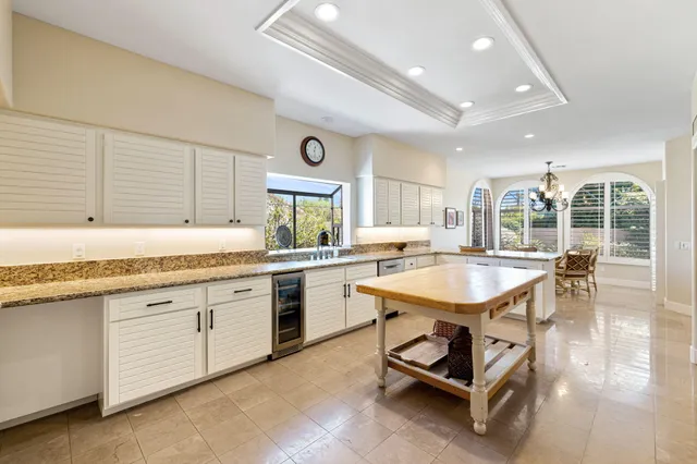 a view of a dining room with furniture wooden floor and chandelier