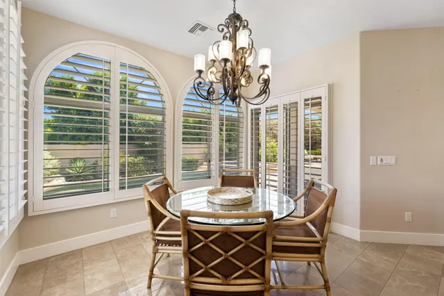 a view of a dining room with furniture window and outside view