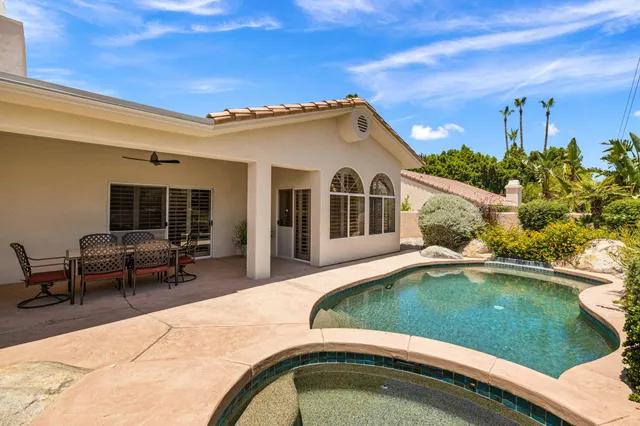 a bedroom with a bed a couch and a window