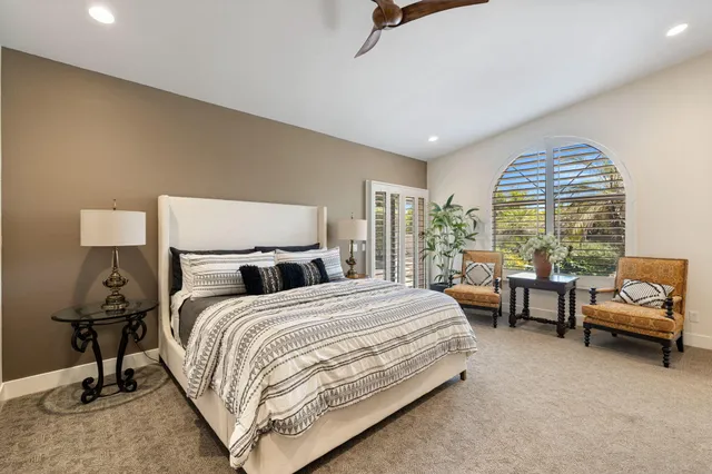 a bathroom with a tub a window and a shower