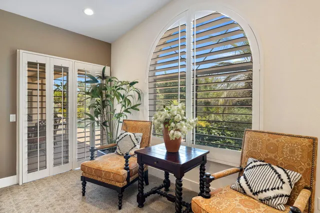 a bedroom with a large bed and wooden floor