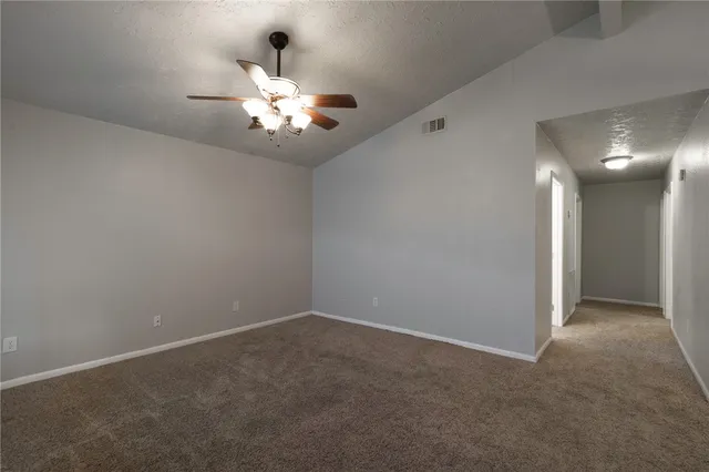 a view of an empty room with a fan