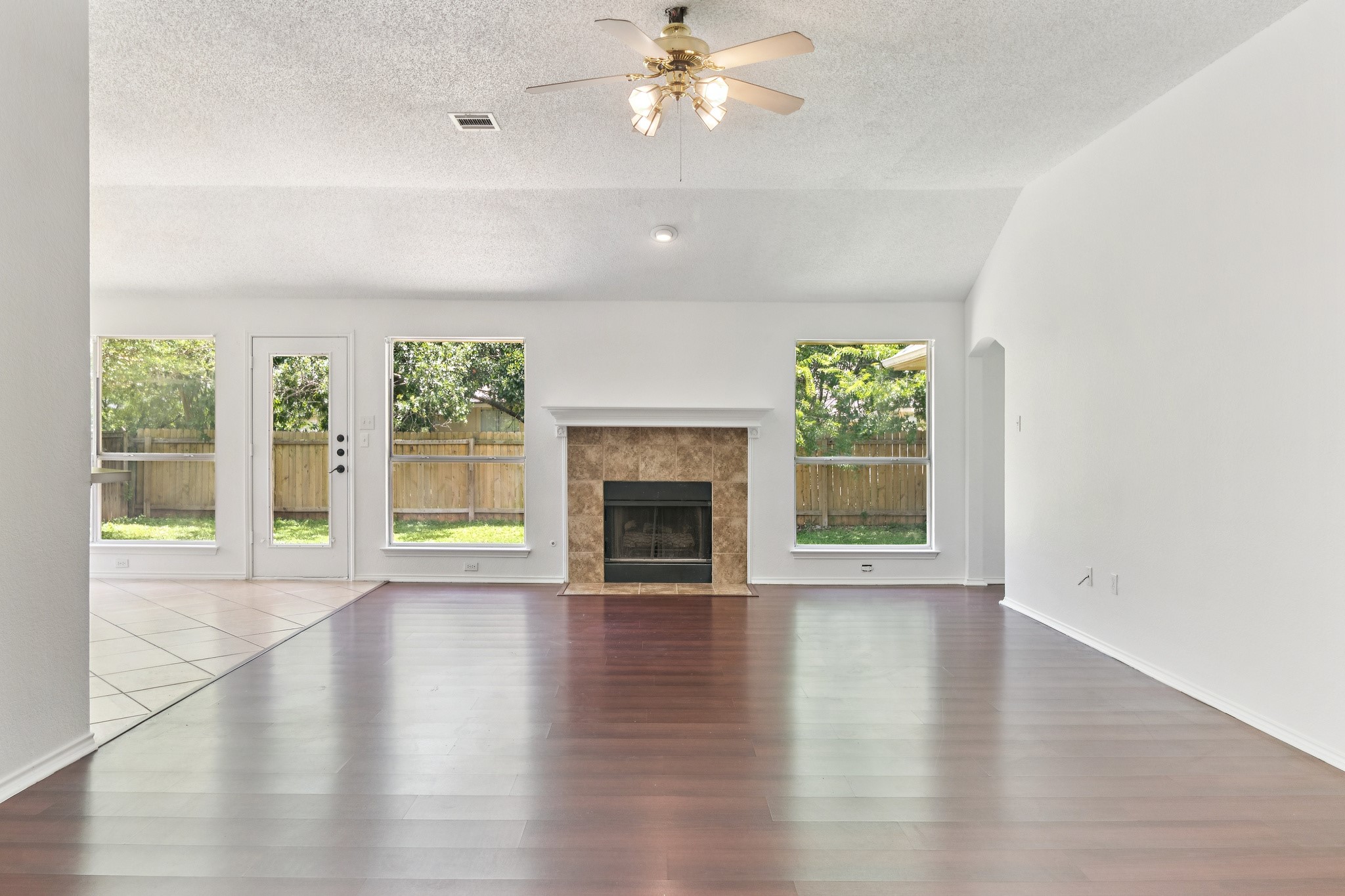 800 Mountain Ridge Drive Leander, TX 78641 - Photo 7 of 31 Gleaming wood floors and a classic tile fireplace anchor this inviting living space.