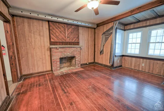 a bed room with a bed window and a flat screen tv
