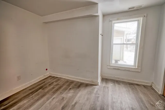 a kitchen with wooden floors and appliances