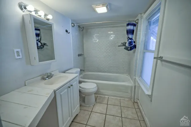 a kitchen with a refrigerator and a stove top oven