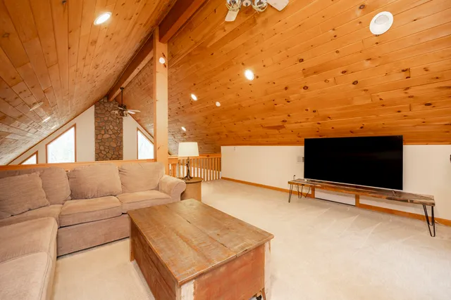 a kitchen with stainless steel appliances granite countertop a refrigerator a stove and a wooden cabinets