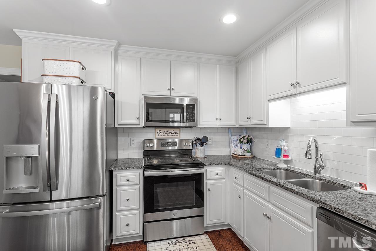 3518 Friday Road Sims, NC 27880 - Photo 21 of 28 a kitchen with white cabinets stainless steel appliances and a sink