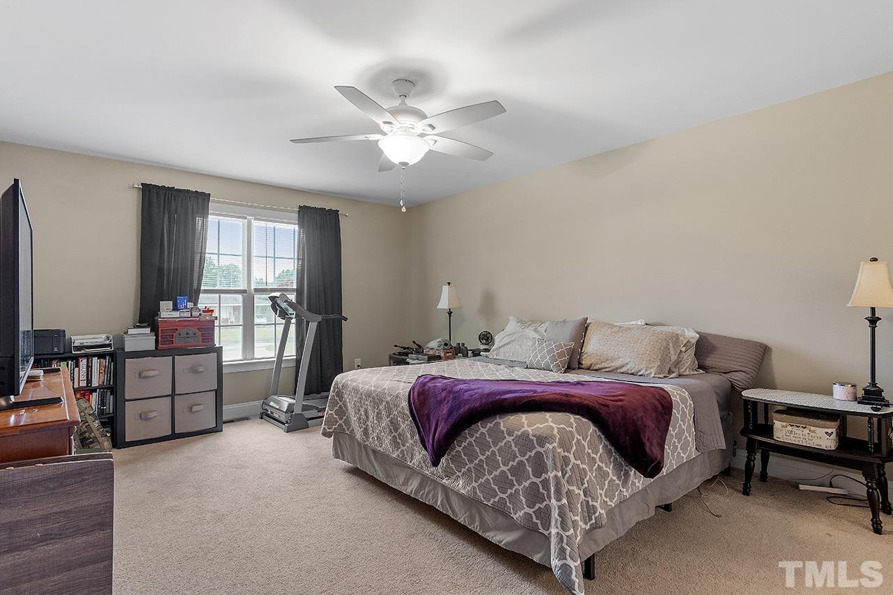 3518 Friday Road Sims, NC 27880 - Photo 22 of 28 a bedroom with a bed and a chandelier