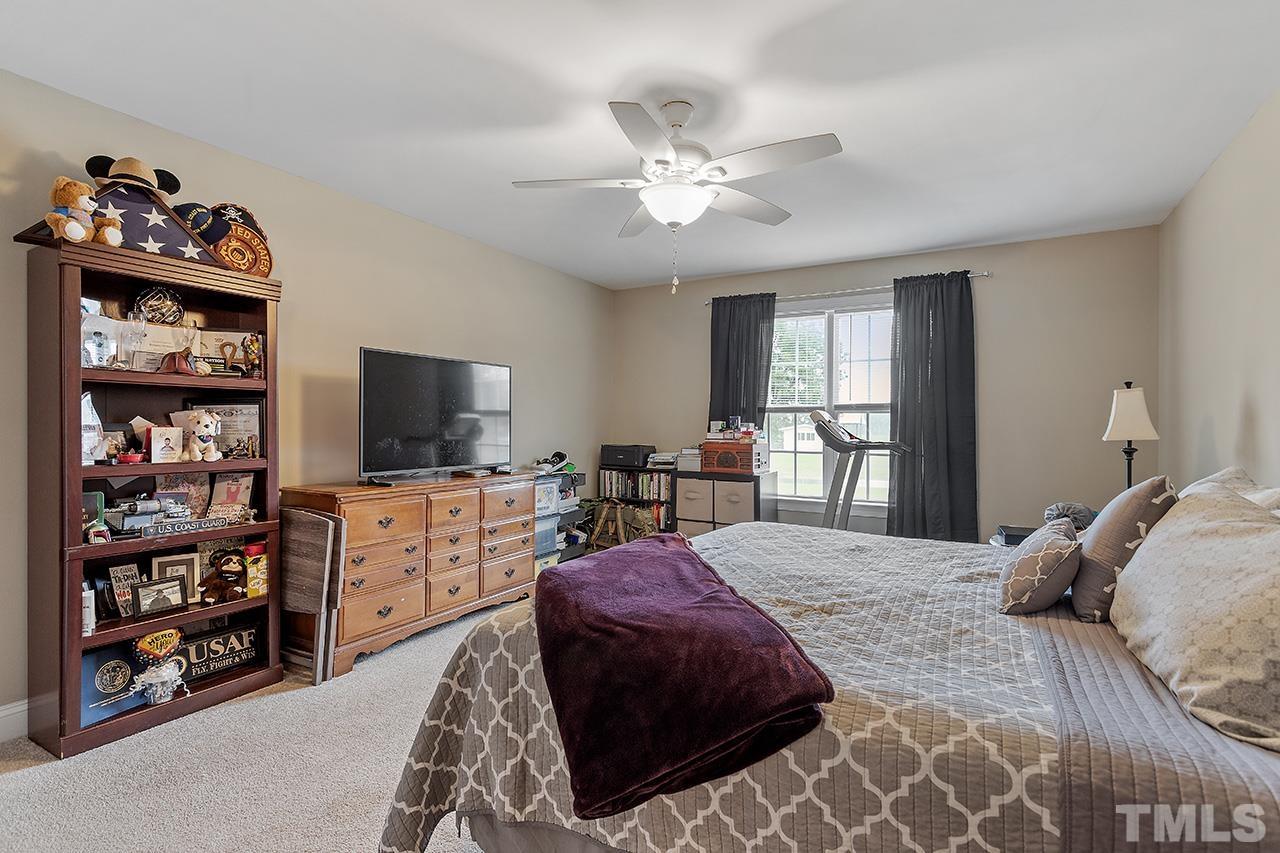 3518 Friday Road Sims, NC 27880 - Photo 23 of 28 a bedroom with a bed a dresser and a flat screen tv