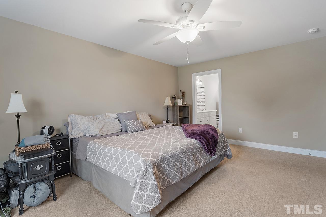 3518 Friday Road Sims, NC 27880 - Photo 24 of 28 a bedroom with a bed and a chandelier