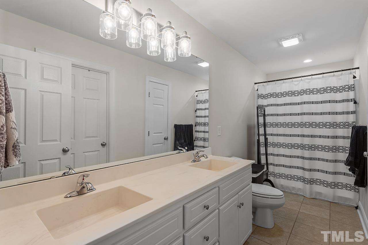 3518 Friday Road Sims, NC 27880 - Photo 25 of 28 a bathroom with a toilet a sink and mirror