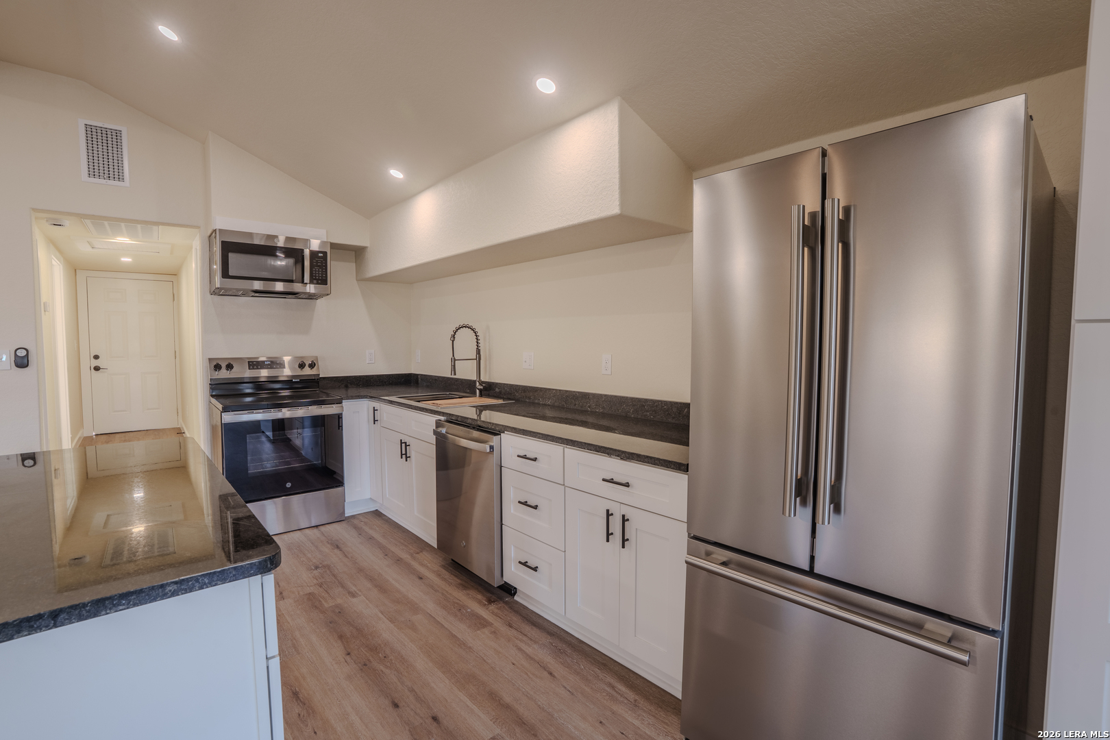 3206 La Rosa Street San Antonio, TX 78211 - Photo 6 of 18 a kitchen with a refrigerator and a sink