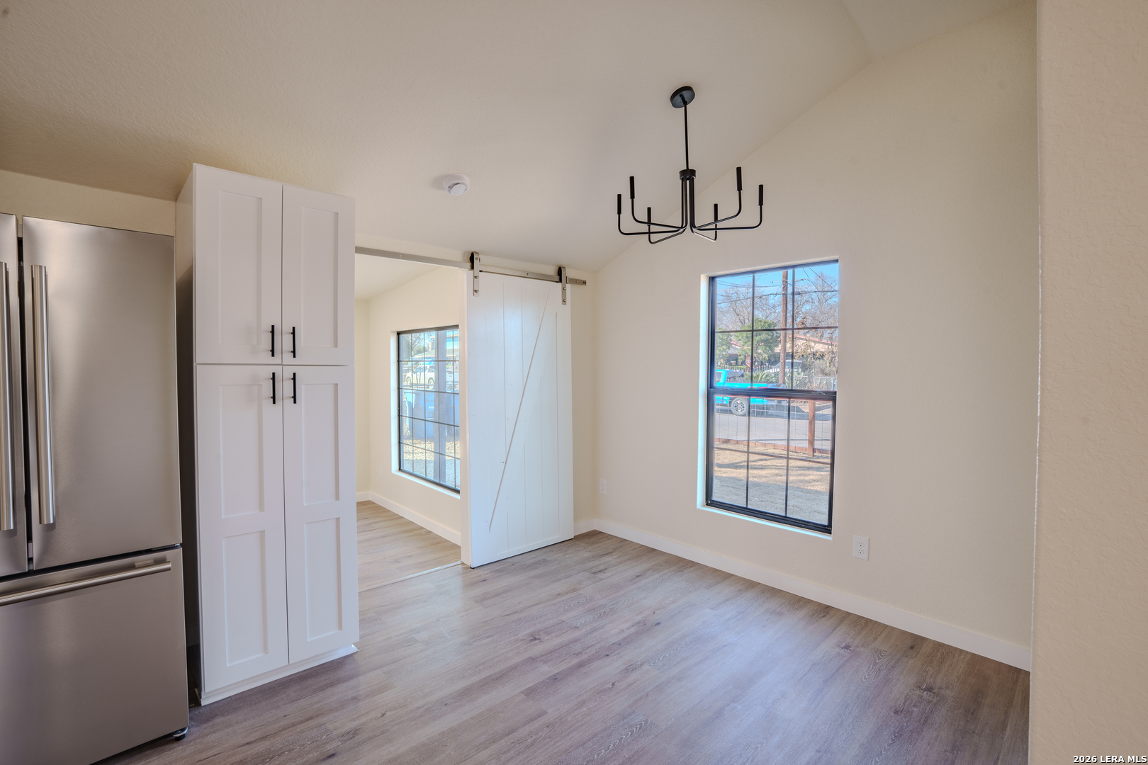 3206 La Rosa Street San Antonio, TX 78211 - Photo 7 of 18 a view of an empty room with window and wooden floor