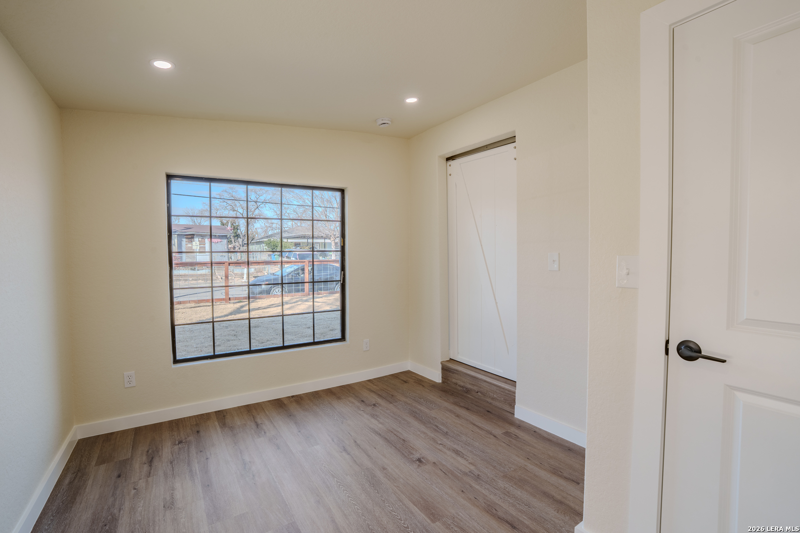 3206 La Rosa Street San Antonio, TX 78211 - Photo 8 of 18 an empty room with wooden floor and windows