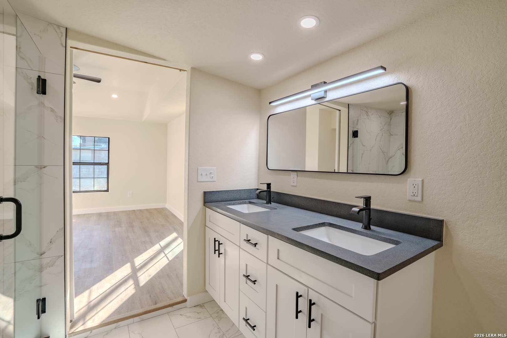 3206 La Rosa Street San Antonio, TX 78211 - Photo 10 of 18 a bathroom with a sink double vanity and a mirror