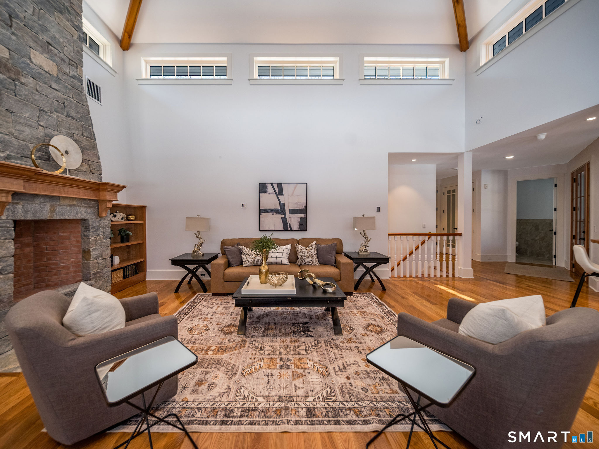 81 Strawberry Hill Road Madison, CT 06443 - Photo 12 of 40 a living room with furniture wooden floor and a fireplace