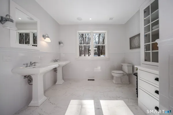a spacious bathroom with a shower sink and mirror