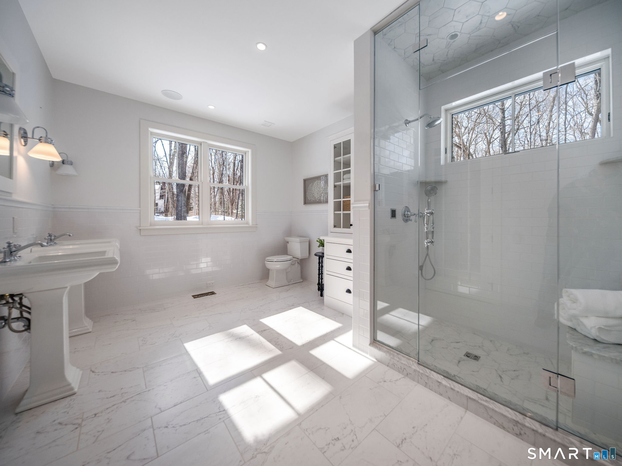 81 Strawberry Hill Road Madison, CT 06443 - Photo 19 of 40 a spacious bathroom with a shower sink and mirror