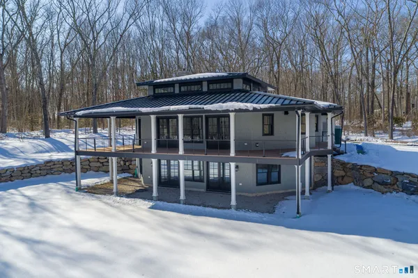 a view of a house with a yard and wooden fence
