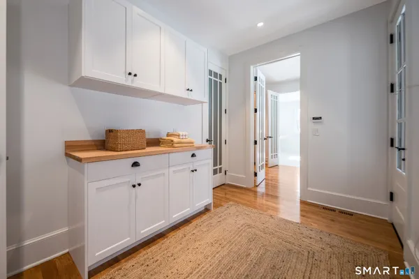 a bathroom with a granite countertop toilet sink and mirror