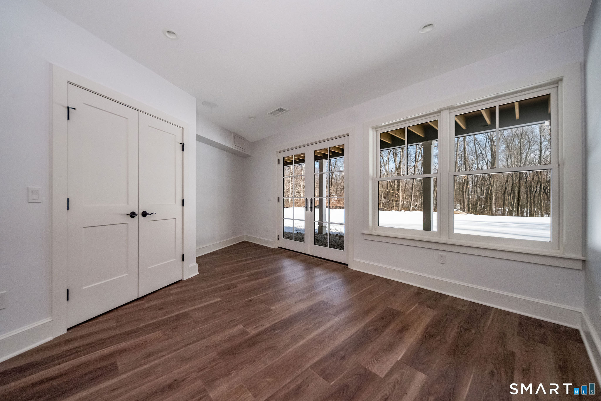 81 Strawberry Hill Road Madison, CT 06443 - Photo 31 of 40 a view of an empty room with wooden floor and a window