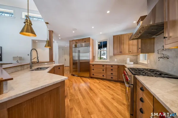 a kitchen with stainless steel appliances granite countertop a stove and a refrigerator