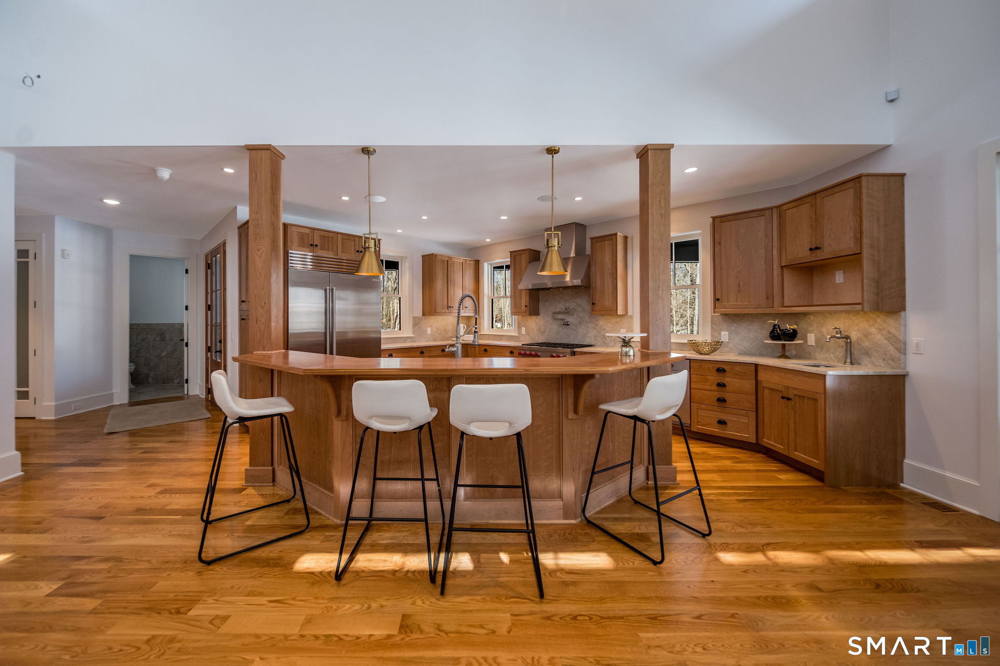 81 Strawberry Hill Road Madison, CT 06443 - Photo 10 of 40 a kitchen with stainless steel appliances kitchen island granite countertop a table and chairs in it