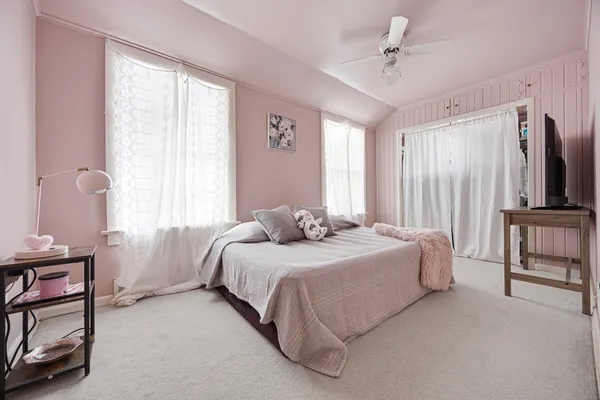 a bedroom with a bed furniture and a window