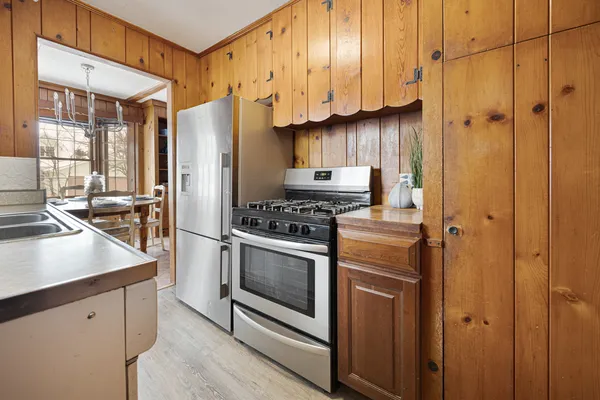 a kitchen with stainless steel appliances a refrigerator stove and sink