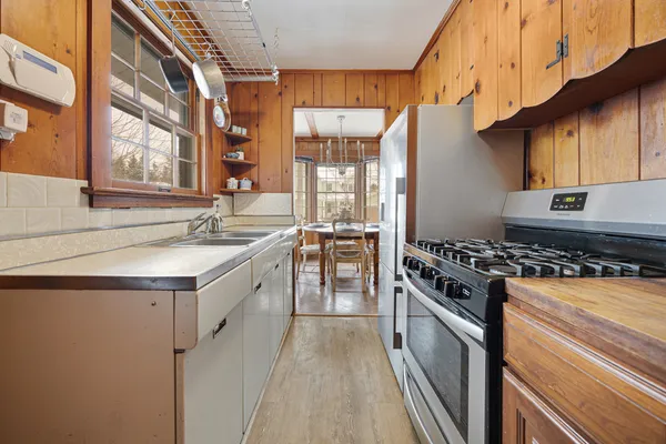 a kitchen with a stove a sink and a refrigerator