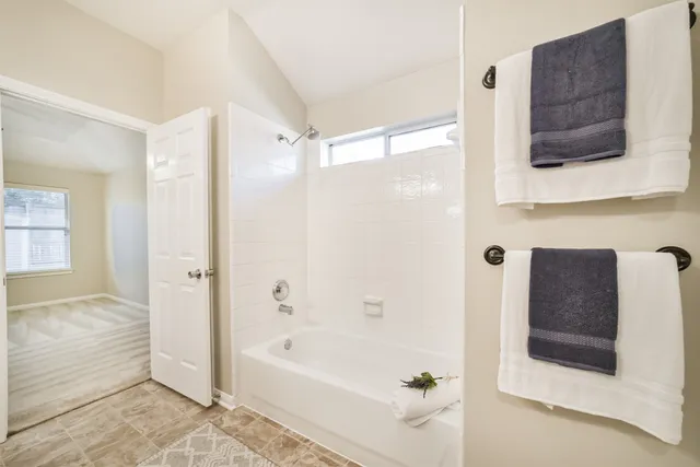 a bathroom with a bathtub and a shower