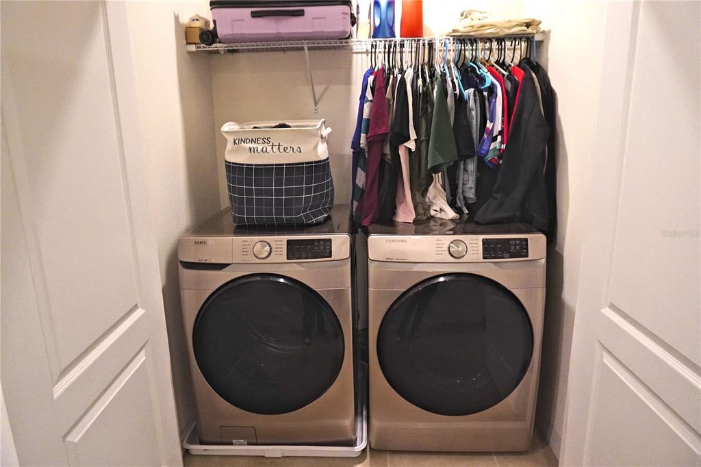 12418 Bowes Branch Road Orlando, FL 32824 - Photo 12 of 21 a view of walk in closet with clothes and shoes